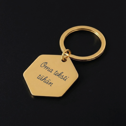 Hexagon-avaimenperä omalla tekstillä – laserkaiverruksella personoitu ruostumattomasta teräksestä